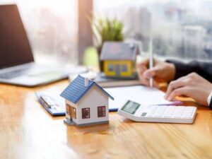 Home purchase documents and property model reviewed during a mortgage survey closing in Washington, DC
