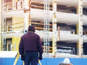 ALTA title surveyor measuring a commercial development site in Washington DC before future tenant improvements.