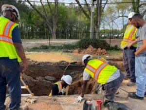 Construction crew working on a utility extension guided by construction staking in Washington DC.